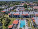 Aerial view of condo community featuring a pool, tennis court, and lush landscaping at 3281 Beneva Rd # 202, Sarasota, FL 34232