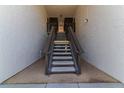 Exterior stairway leading to upper-level units in a condominium complex at 3281 Beneva Rd # 202, Sarasota, FL 34232