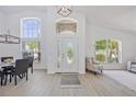 Inviting foyer with soaring ceilings and large windows, offering plenty of natural light at 7001 Cohasset Cir, Riverview, FL 33578
