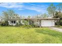 Inviting single-story home with lush green lawn and driveway leading to attached garage at 723 45Th Street W Ct, Palmetto, FL 34221