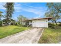 Charming single-story home featuring a well-maintained lawn and a concrete driveway at 723 45Th Street W Ct, Palmetto, FL 34221