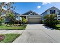Charming single-Gathering home featuring a well-manicured front yard and a two-car garage at 7417 Sungold Meadow Ct, Apollo Beach, FL 33572
