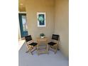 Inviting patio features a cozy table and chairs, perfect for enjoying the outdoors near the front door at 7417 Sungold Meadow Ct, Apollo Beach, FL 33572