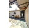 Back porch of home featuring grill, outdoor seating, and entrance to interior at 7939 Pine Dr # 7939, Temple Terrace, FL 33637