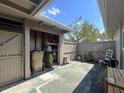 Outdoor patio with shed, storage shelving, and wooden fence at 7939 Pine Dr # 7939, Temple Terrace, FL 33637