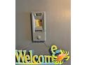 Condo front entrance with cute welcome sign and apartment number at 880 Mandalay Ave # N1004, Clearwater Beach, FL 33767