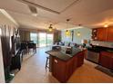 Open floor plan with access to the balcony and a modern kitchen at 880 Mandalay Ave # N1004, Clearwater Beach, FL 33767