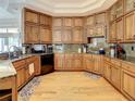 Spacious kitchen featuring wood cabinets, stone countertops, and stainless appliances at 8907 Magnolia Chase Cirs, Tampa, FL 33647