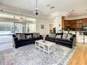 Bright living room with hardwood floors, chandelier lighting, and open access to pool at 8907 Magnolia Chase Cirs, Tampa, FL 33647