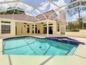 Enclosed pool area with patio, covered porch, and attached spa for outdoor living at 8907 Magnolia Chase Cirs, Tampa, FL 33647