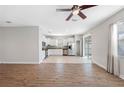 Open-concept living space with updated floors and lots of natural light next to the kitchen at 11207 Flora Springs Dr, Riverview, FL 33579
