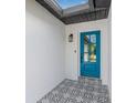 Stylish front entryway featuring decorative tile flooring and a modern blue door with glass inserts at 12641 98Th St, Largo, FL 33773