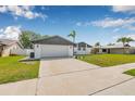 View of a house with clean landscaping and a paved driveway leading to the attached garage at 12641 98Th St, Largo, FL 33773