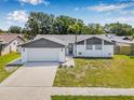 An elevated view of this home showcases its tidy landscaping and attached two-car garage at 12641 98Th St, Largo, FL 33773