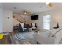 Bright living room with modern furniture, stairwell, and vinyl flooring at 1411 Gray S St, Gulfport, FL 33707