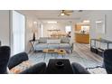 Bright living room with open floor plan, modern furniture, and vinyl flooring at 1411 Gray S St, Gulfport, FL 33707