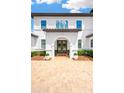 Up-close view of the front entrance with double doors and a paver driveway at 16419 Chapman Crossing Dr, Lithia, FL 33547