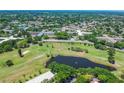 Expansive aerial view of the community, golf course, pond, and surrounding landscape at 2430 Florentine Way # 46, Clearwater, FL 33763