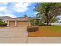 Charming home with three-car garage, mature trees, and beautiful landscaping at 2539 Centennial Falcon Dr, Valrico, FL 33596