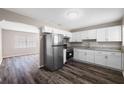 Modern kitchen featuring stainless steel appliances, granite countertops, and white cabinetry at 2916 E North St, Tampa, FL 33610