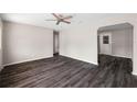 Spacious living room featuring dark hardwood flooring and a ceiling fan at 2916 E North St, Tampa, FL 33610