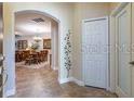 Inviting entryway with neutral tile flooring leading to the dining area and other rooms at 305 Bluewater Falls Ct, Apollo Beach, FL 33572