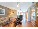 Inviting living room featuring hardwood floors, ceiling fan, and a comfortable seating arrangement with natural light at 3066 19Th Sw Pl, Largo, FL 33774