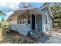Charming light blue house, with a white awning, manicured lawn, and a freshly painted entrance at 3409 N 10Th St, Tampa, FL 33605