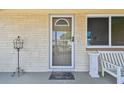 Charming front door with a glass insert, decorative accents, and a 'welcome' mat at 3514 Truman Dr, Holiday, FL 34691