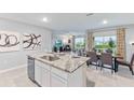 Open concept kitchen featuring granite countertops, stainless steel appliances, and seamless flow into living spaces at 35688 Lockman Way, Zephyrhills, FL 33541