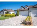 Beautiful home showcasing a well-maintained exterior, a paved driveway, and lush landscaping at 4405 Barletta Ct, Wesley Chapel, FL 33543