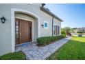 Charming home exterior showcases a welcoming front door, manicured landscaping, and a brick walkway at 4405 Barletta Ct, Wesley Chapel, FL 33543