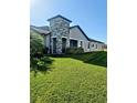 Side view of house showcasing landscaping and stone column feature at 5154 Brickwood Rise Dr, Wimauma, FL 33598