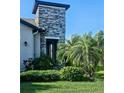 Close up of the stone column element of this charming home, and beautiful landscaping at 5154 Brickwood Rise Dr, Wimauma, FL 33598
