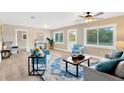 Bright living room with wood-look flooring, natural light, and comfortable seating at 602 Stephens Rd, Ruskin, FL 33570