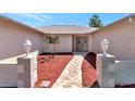 Inviting walkway leading to double doors with decorative glass and landscaped front yard at 6056 Fall River Dr, New Port Richey, FL 34655
