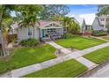 Charming bungalow with beautiful landscaping, walkway, and a welcoming front porch at 636 16Th Ne Ave, St Petersburg, FL 33704