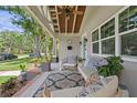 Cozy front porch with comfortable seating, ceiling fan, and views of the landscaped front yard at 636 16Th Ne Ave, St Petersburg, FL 33704