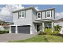 Charming two-story home with a two-car garage, dark shutters, and a well-maintained lawn at 714 S Lois Ave, Tampa, FL 33609