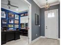 Home office with wood floors, blue walls, and lots of decor, featuring a black desk and white door at 714 S Lois Ave, Tampa, FL 33609