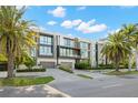 Modern townhomes with two-car garages, large windows, and professional landscaping on a sunny day at 98 W Davis Blvd, Tampa, FL 33606