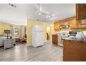 Bright kitchen featuring wood cabinets, modern appliances, and open living space at 1019 Goshen Rd, Tarpon Springs, FL 34689