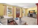 Bright living room with stylish furniture, wood-look floors, and large windows at 1019 Goshen Rd, Tarpon Springs, FL 34689