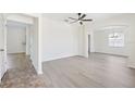 Bright living room featuring sleek, light-toned flooring and arched entryway to a dining area at 11907 Streambed Dr, Riverview, FL 33579