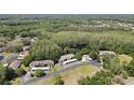 Aerial view of the condominium community with trees, landscaping, and green space at 12155 Environmental Dr # 3, New Port Richey, FL 34654
