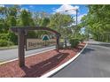 Baywood Meadows community sign nestled amongst lush landscaping along the roadside at 12155 Environmental Dr # 3, New Port Richey, FL 34654