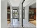 Hallway features tile flooring, closet with mirrored doors, and entry to the kitchen at 12155 Environmental Dr # 3, New Port Richey, FL 34654