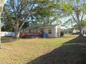 Large backyard with a wooden deck, offering ample space for outdoor activities and relaxation at 125 80Th N Ave, St Petersburg, FL 33702