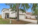 This home includes a two-car garage and well-manicured landscaping at 12508 Evington Point Dr, Riverview, FL 33579
