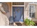 Charming blue front door featuring a decorative wreath and tiled entrance at 12523 Riverglen Dr, Riverview, FL 33569